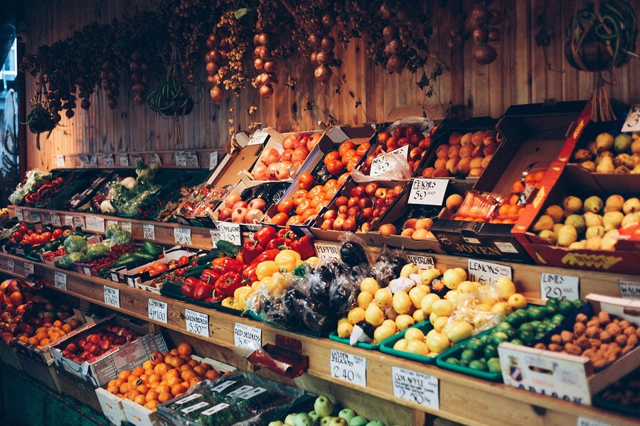 A greengrocers' shelves of fruits and vegetables.