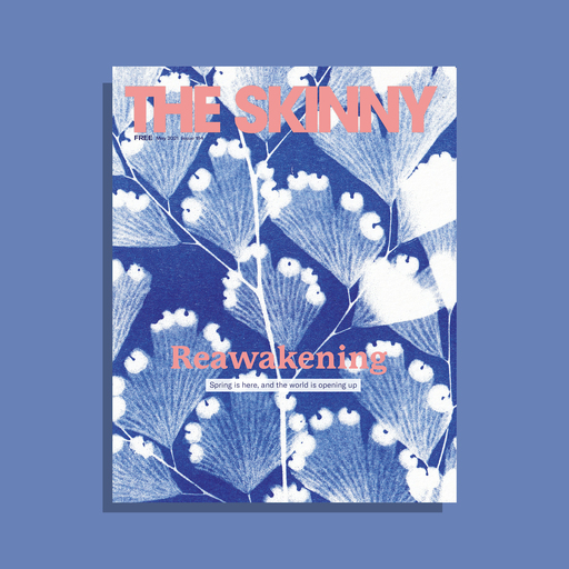 The cover of The Skinny's May 2021 issue. The main image is a blue and white pattern of leaves rising up the page; pink text at the top of the page reads 'The Skinny', with the word 'Reawakening' in pink at the centre of the image. Underneath is the additional text 'Spring is here, and the world is opening up'.