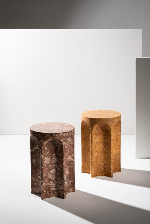 A pair of hexagonal side tables in various brown shades, against a white and grey background