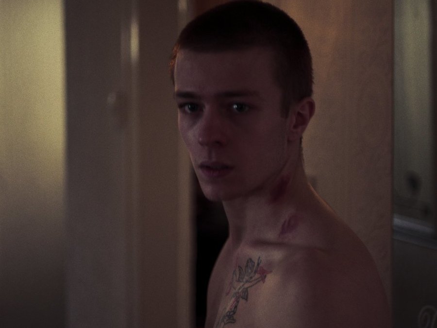 A shirtless man looks into the camera, in a still from the short film Too Rough.