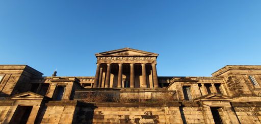 The facade of the Old Royal High School in daylight