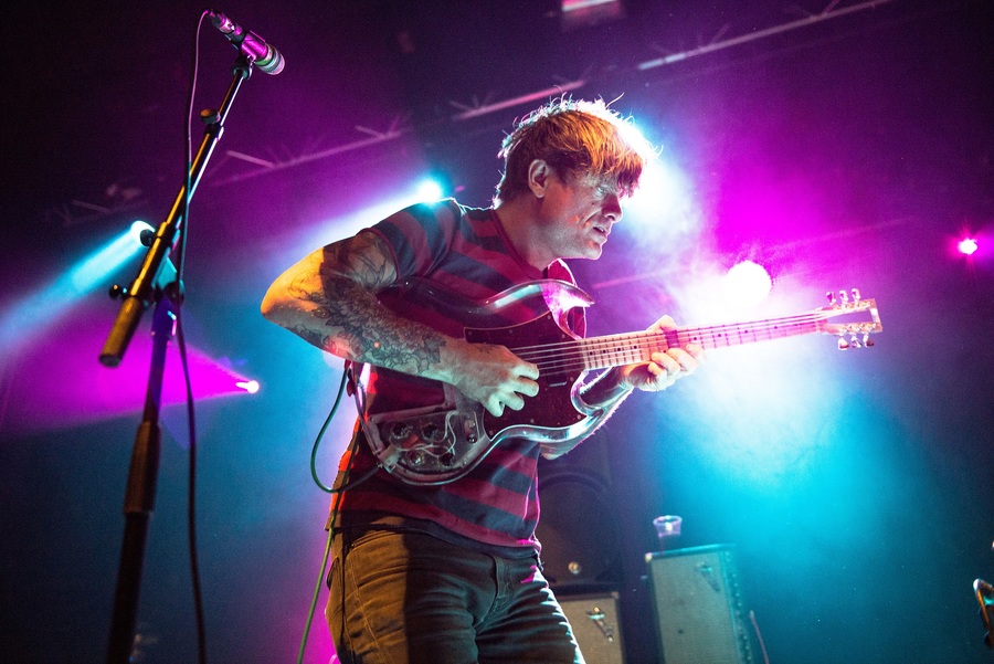 John Dwyer of Oh Sees, playing a translucent electric guitar.