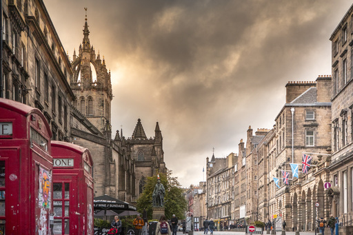 The Royal Mile at dusk, with two red phone boxes visible in the foreground.