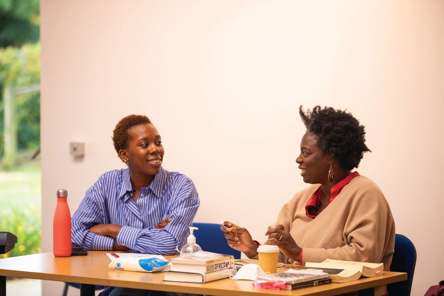 Tomiwa Folorunso and Adebusola Ramsay in conversation behind a short table.