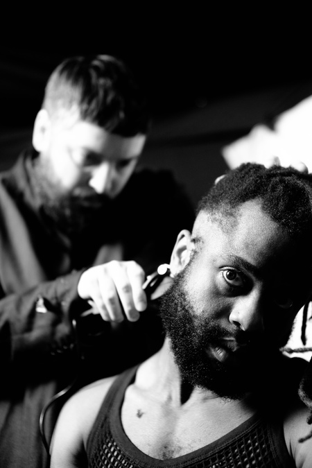 Graham G Hastings of Young Fathers cuts the hair of his bandmate Kayus Bankole