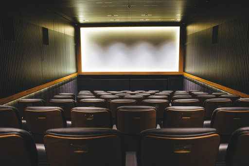Glasgow Film Theatre. A screening room viewed from behind, with a bright screen at the front.