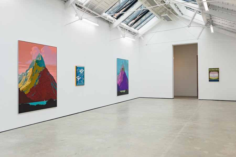 Four paintings hung on the white walls of a gallery.