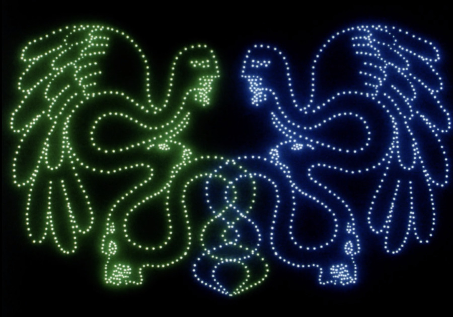 Still from Lesley Keen's Invocation. Two multi-headed beasts are depicted as dots of blue and green light.
