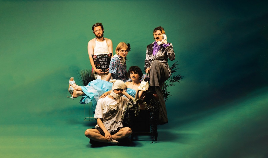 The members of Lloyd's House, sitting in front of a green background.