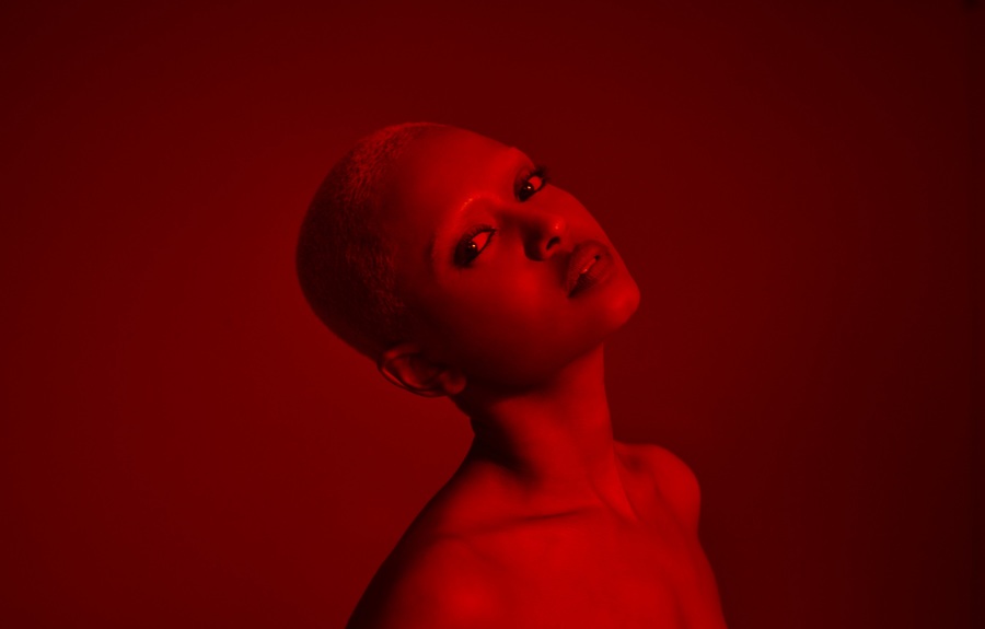 A red-lit photograph of Kelela.