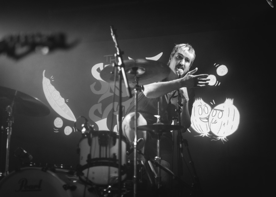 A black and white photograph of Spook School drummer Niall McCamley, on stage at SWG3.