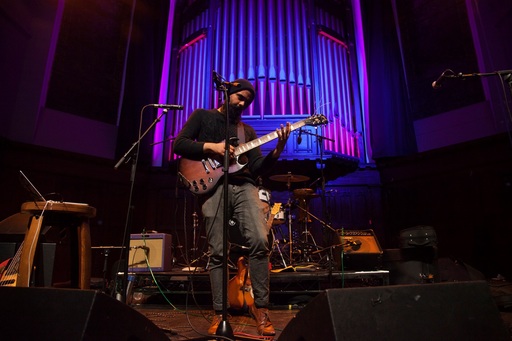 Kapil Seshasayee on stage at St Luke's, Glasgow.