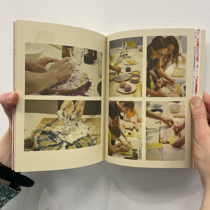 A photograph of a two-page spread of a book. The book depicts people cooking and making food with their hands.