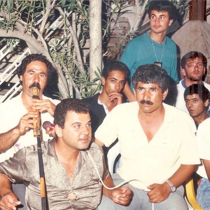 Photograph of a group of Palestinian musicians playing together.