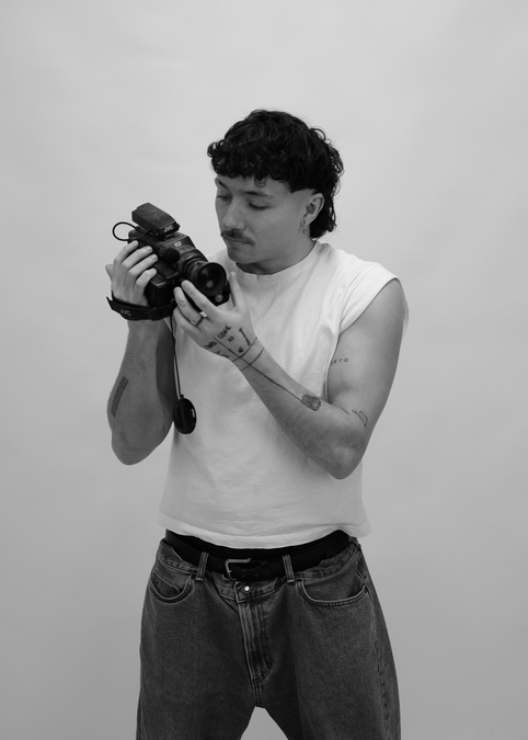 Black and white photo of Leif Coffield, holding a camcorder.