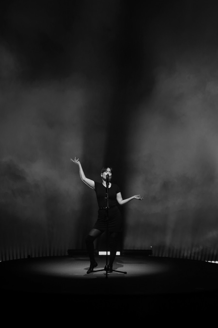Black and white photo of Mitski performing on stage in Edinburgh.