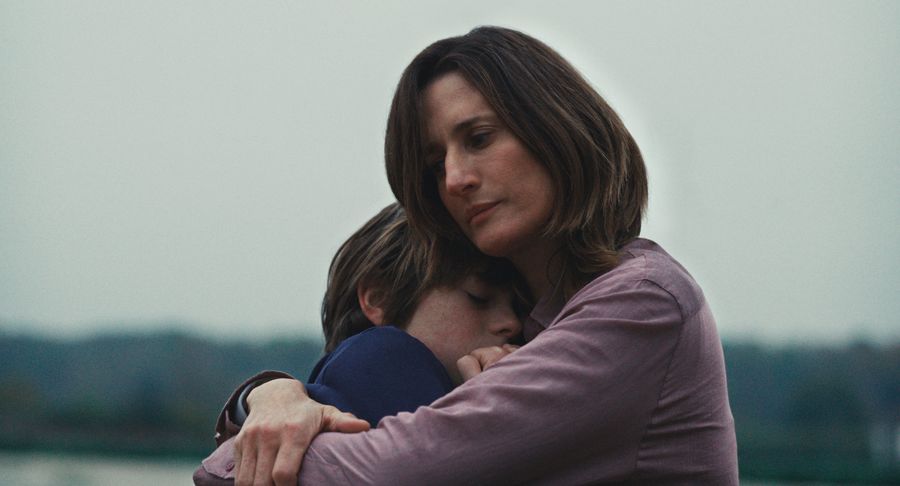 A still from Out of Love; a woman hugging a young boy.