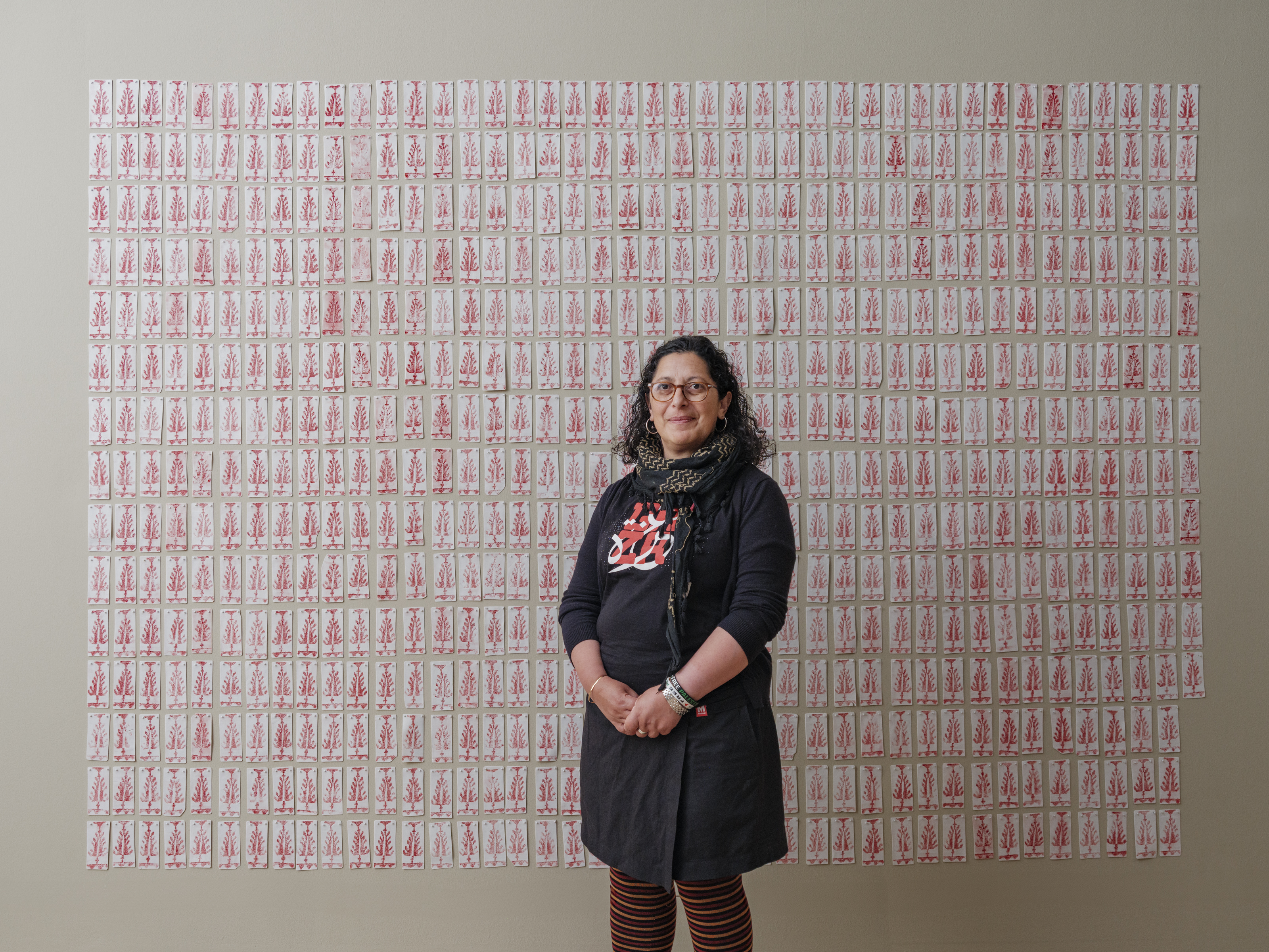 Photo of Leena Nammari in front of her art.
