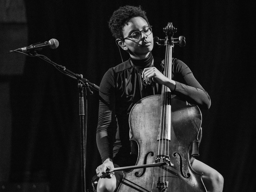Black and white photo of Simone Seales, playing her cello.
