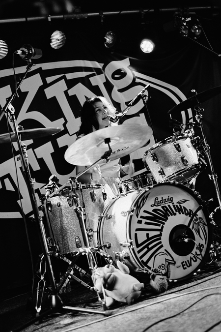 A black and white photo of Mila de la Garza behind a drum kit.
