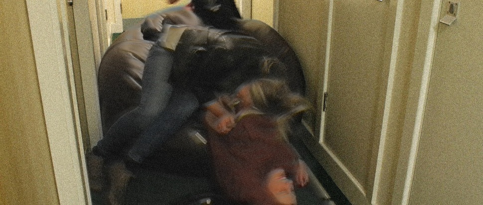 Three people, a hoover and a beanbag return from a quiet night out in halls in 2012