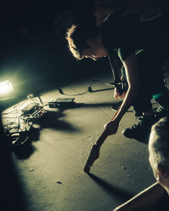Photo of Nina Garcia playing guitar on stage.