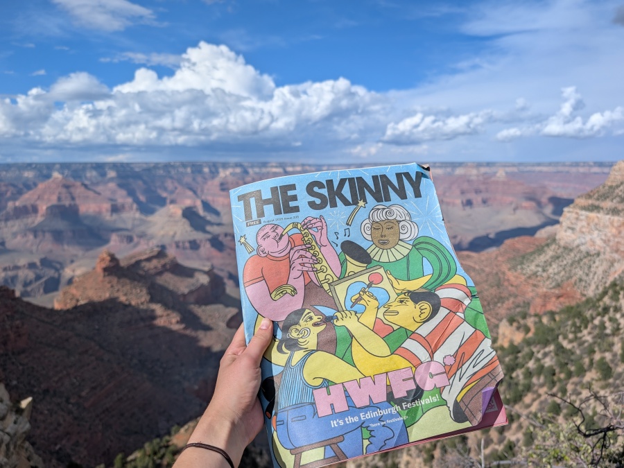Photo of a magazine held in front of an outdoor scene.