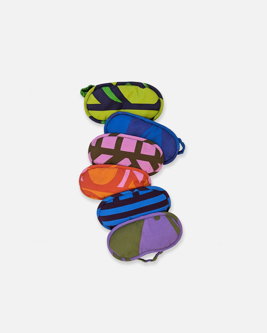 Photo of six patterned sleep masks on a white background.
