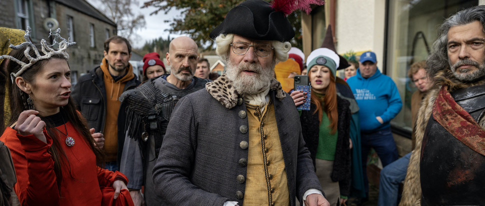 The Fall of Sir Douglas Weatherford - Still - Kenneth (Peter Mullan) and crowd – Credit Saskia Coulson