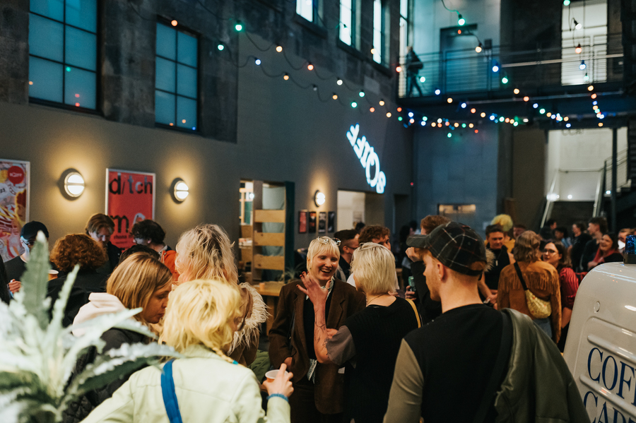 A photo of crowds chatting in the CCA bar.