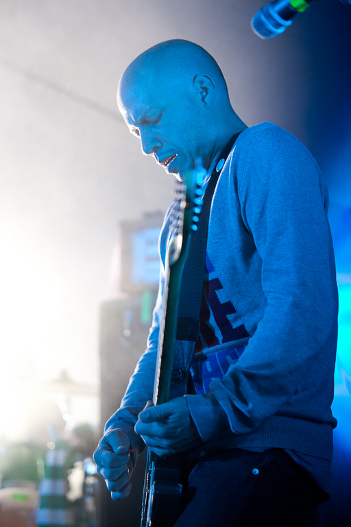 Stuart Braithwaite of Mogwai plays guitar on stage under blue lighting